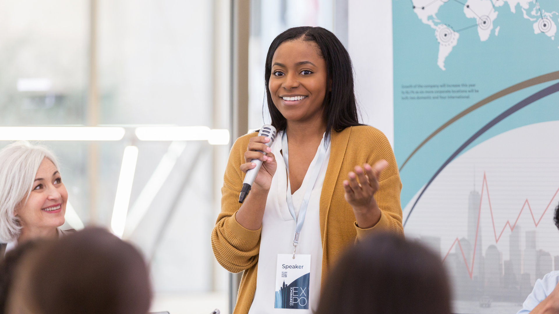 An image showing a woman speaking at an event